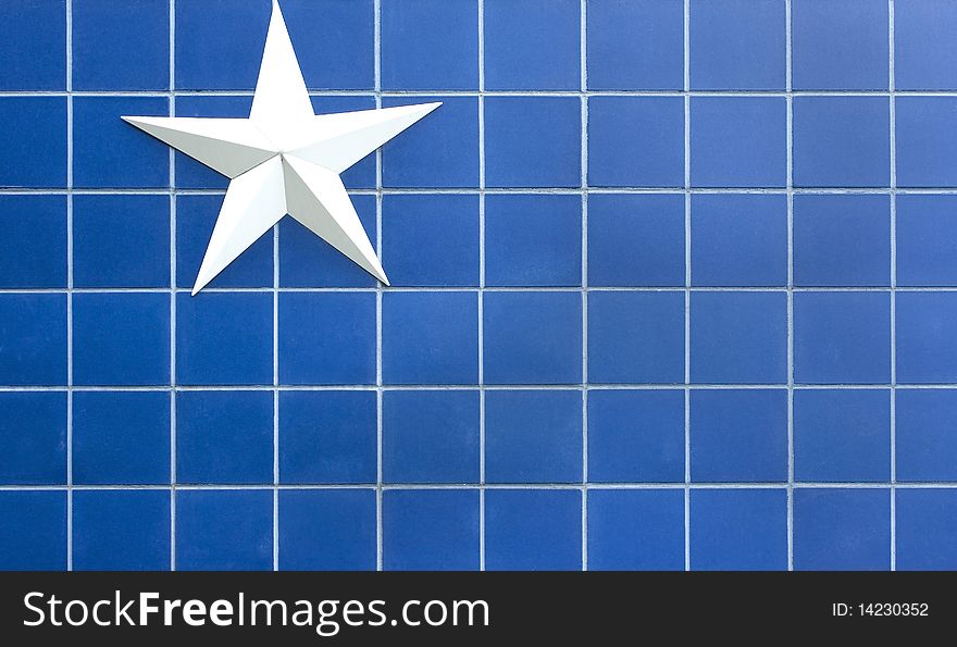 Simple white star against a blue tiled background. Simple white star against a blue tiled background