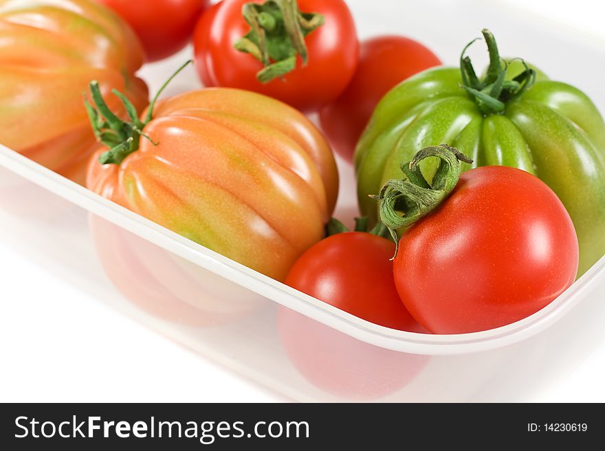 Red And Green Tomatoes On A Plastic Box Isolated