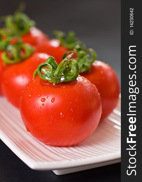Ripe Red Tomatoes On A White Plate. Ripe Red Tomatoes On A White Plate
