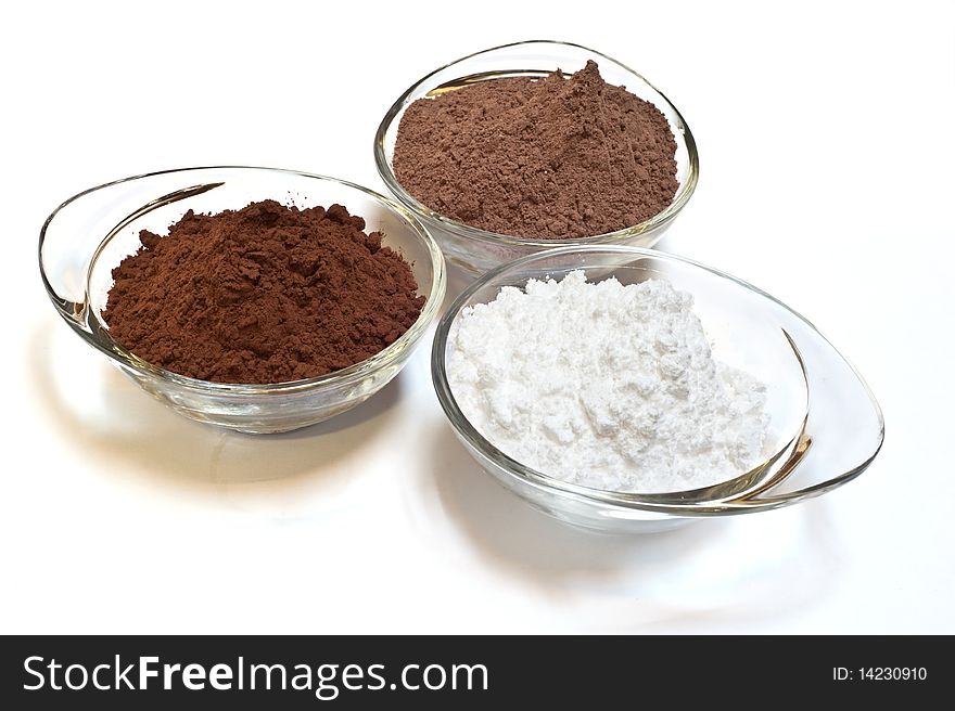 Cocoa cake and cocoa powder on a white background. Cocoa cake and cocoa powder on a white background