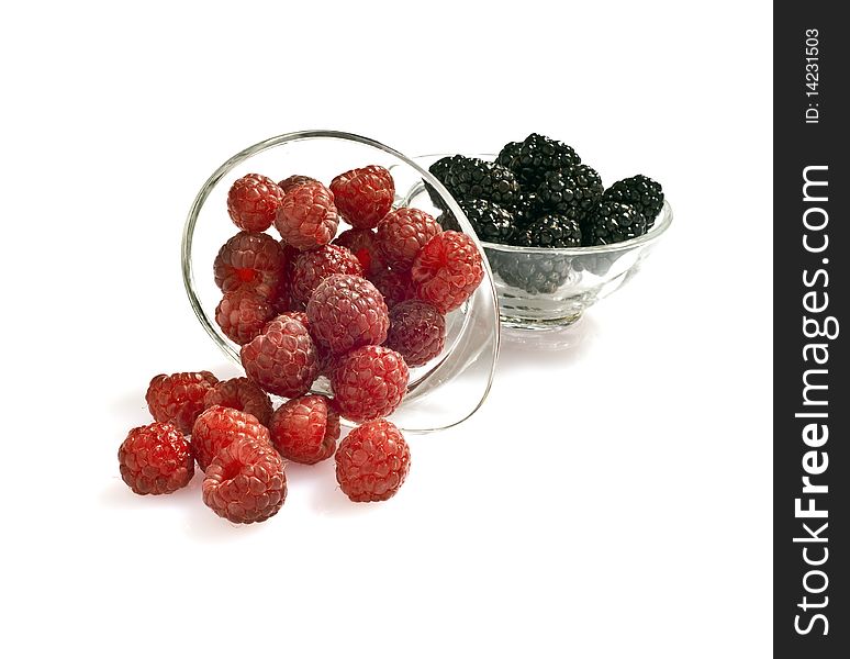 Blackberries and raspberries on white background