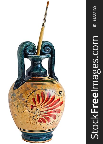 Replica of traditional greek vase with colorful red drawings and brush standing in it. Replica of traditional greek vase with colorful red drawings and brush standing in it