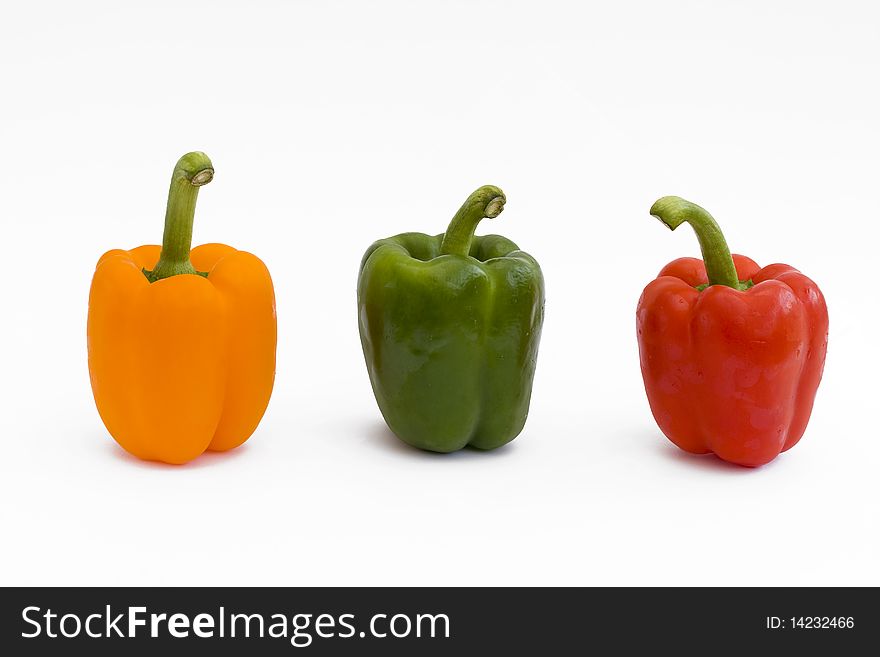 Red yellow and green peppers isolated on white. Red yellow and green peppers isolated on white