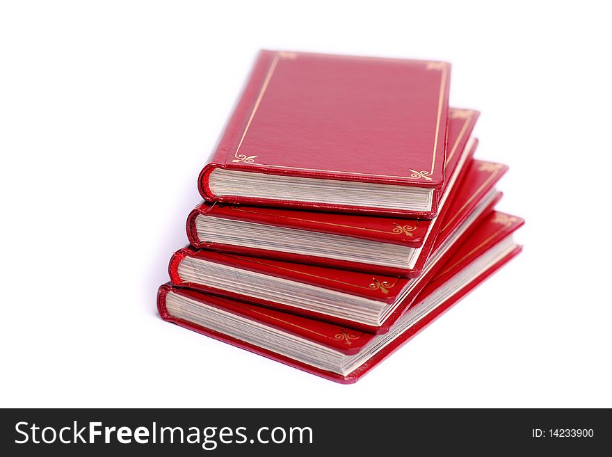 Four red books stacked up against white background. Four red books stacked up against white background