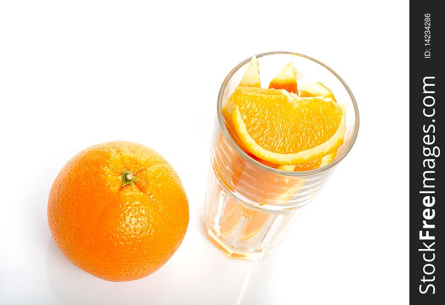 Orange and slices in glass isolated on white background