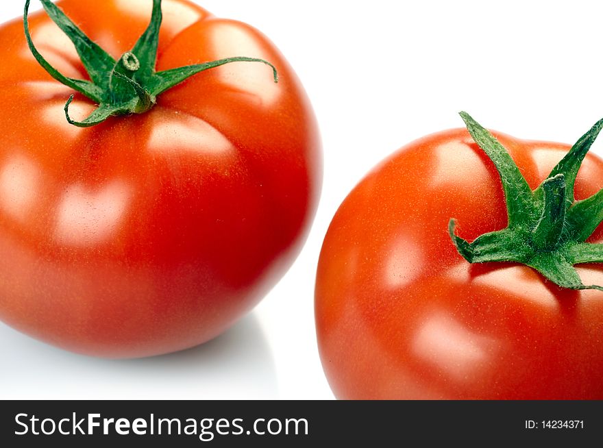 Two tomatoes isolated on white background