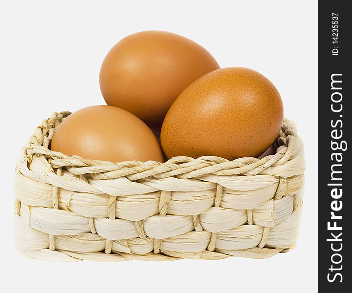 Eggs lie in basket on white background