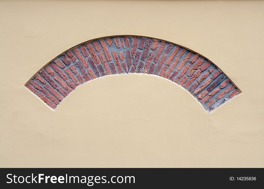 Brick arch in a yellow plastered wall. Brick arch in a yellow plastered wall.