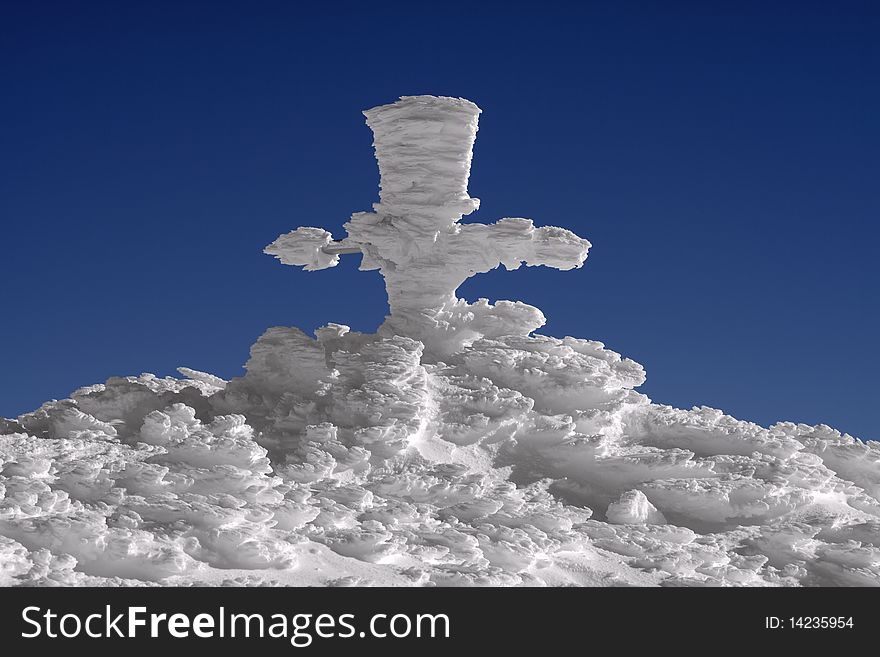 Gore's cross at Omu Peak 2500m , Bucegi Mountains, Carpathians, Romania, covered with hoar-frost. Gore's cross at Omu Peak 2500m , Bucegi Mountains, Carpathians, Romania, covered with hoar-frost.