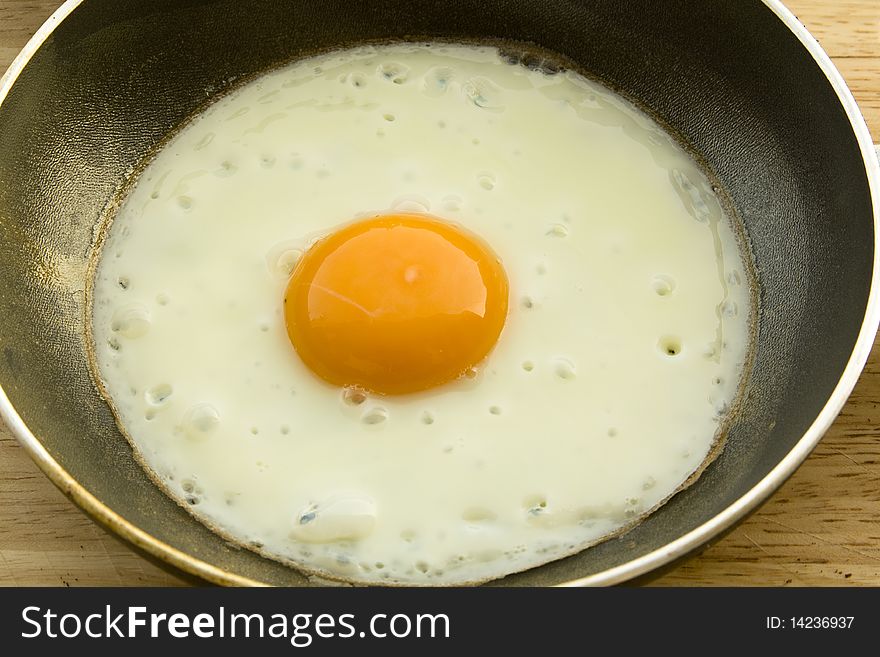 One fryed egg on steel pan
