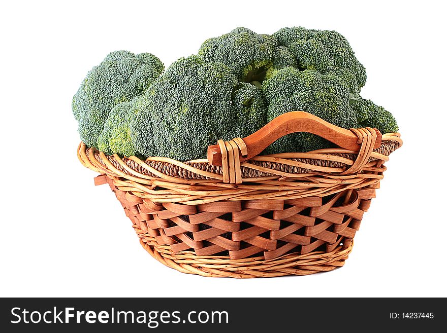 Crop of cabbage of a broccoli in a wattled basket on a white background.