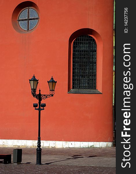 Street lamp on deep red wall