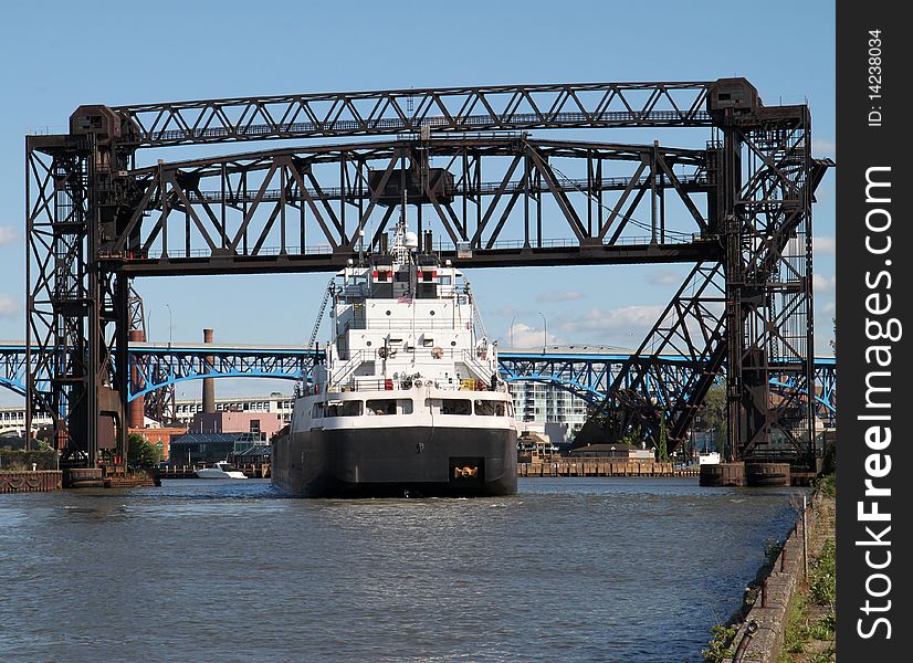 Ship going under a raised railroad bridge. Ship going under a raised railroad bridge