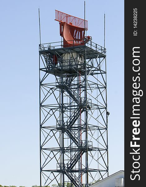 An air traffic controll radar against a blue sky.