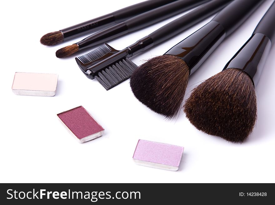 Brushes to make-up and collection of eye shadow on white background. Brushes to make-up and collection of eye shadow on white background