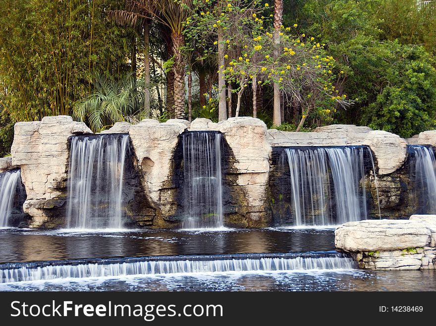 Tropical waterfalls surrounded by lush trees and vegetation