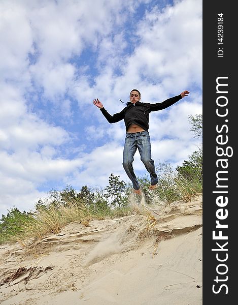 An image showing young boy jumping on the beach. An image showing young boy jumping on the beach