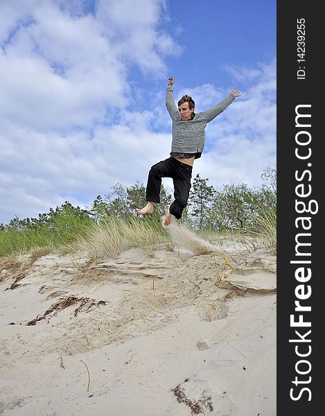 An image showing young boy jumping on the beach. An image showing young boy jumping on the beach