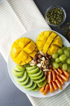Free Delicious Fruits Platte Isolated. Mango, Kiwi, Citrus, Nuts, Grapes. Mix Of Various Exotic Fruits. Healthy Fruit Salad, Healthy Stock Images - 142395554