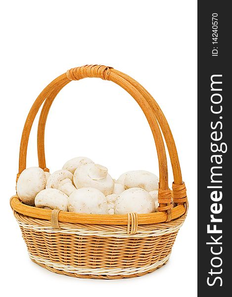 Wattled basket with field mushrooms isolated over white