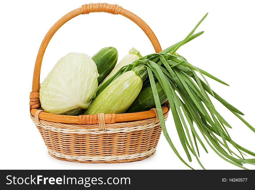 Wattled basket with vegetables  isolated on white