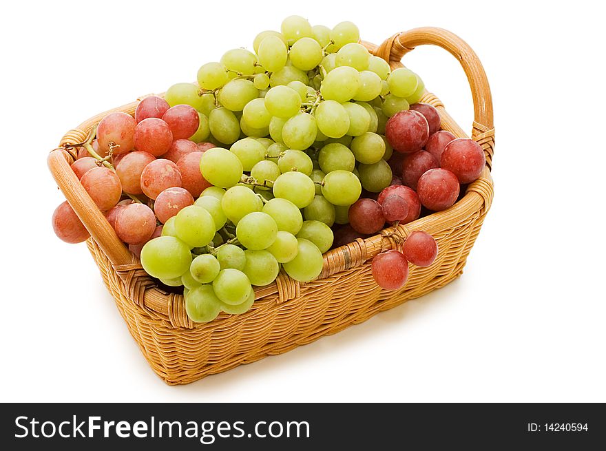 Wattled basket with grapes isolated on white
