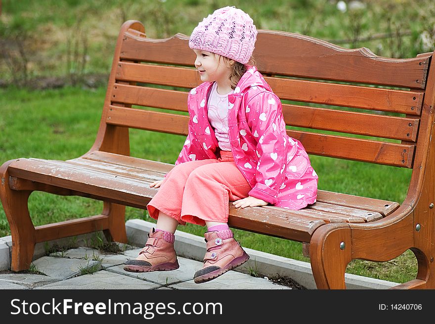 Portrait Little girl in park on a bench