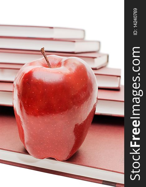 Stack of books and apple isolated over white