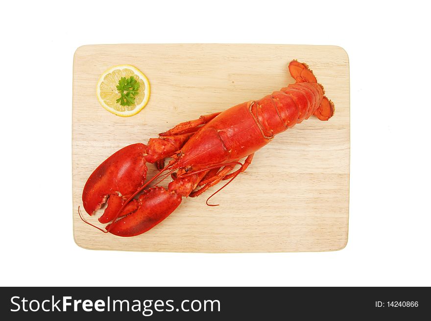 Whole cooked lobster on a wooden board viewed from above