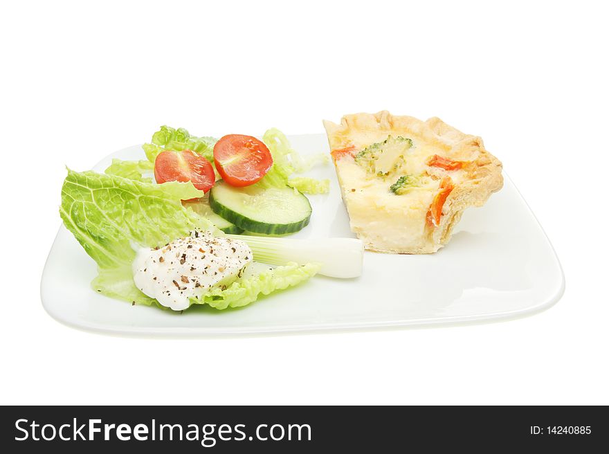 Slice of quiche with a salad on a plate. Slice of quiche with a salad on a plate