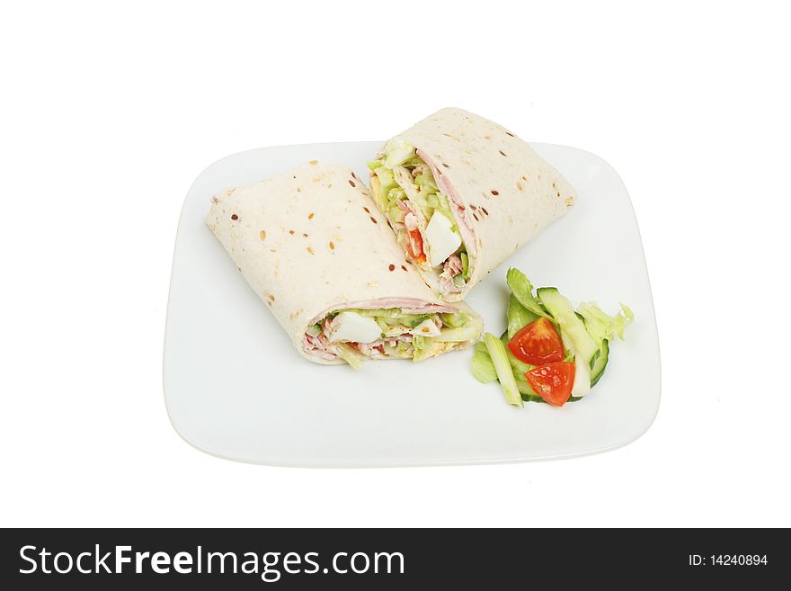 Ham and egg salad bread wraps on a plate