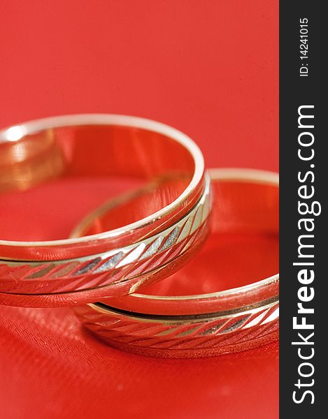 Two Gold Wedding Rings On The Red