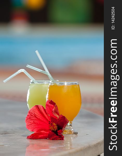 Two tropical cocktails on a table