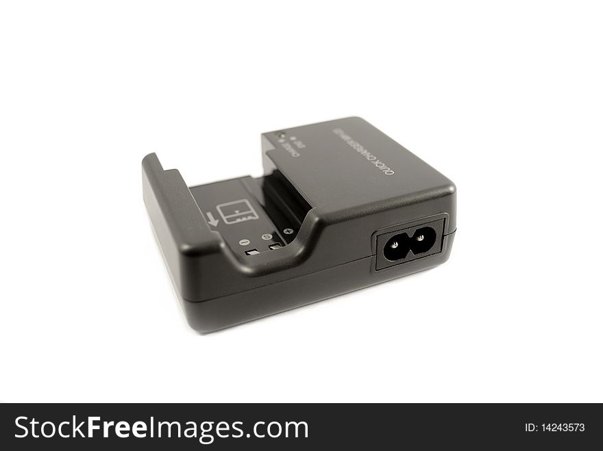 Battery charger with DSLR battery isolated on white.