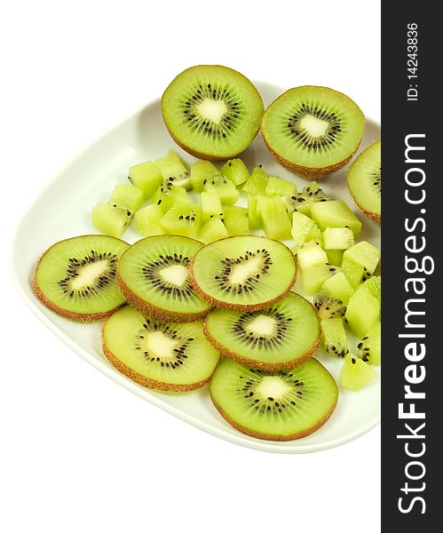 Slices of the kiwi on the white plate. Slices of the kiwi on the white plate