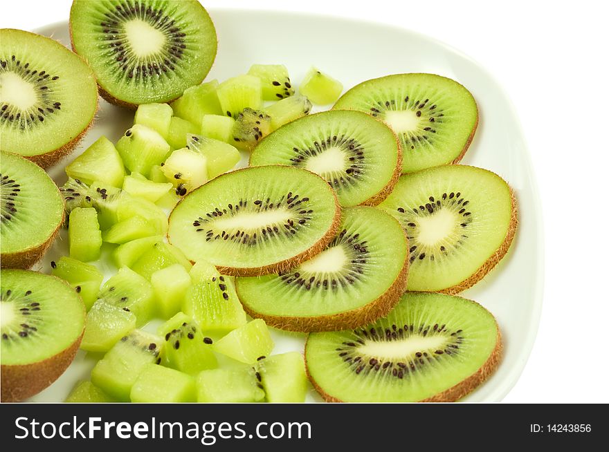 Slices of the kiwi on the white plate. Slices of the kiwi on the white plate