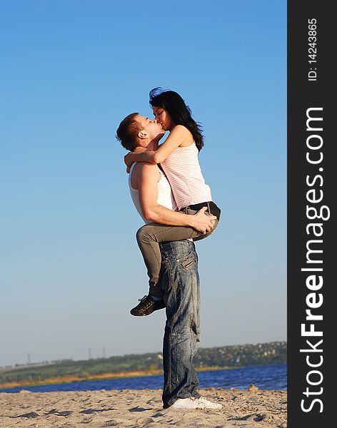 Couple kissing on the beach. Couple kissing on the beach