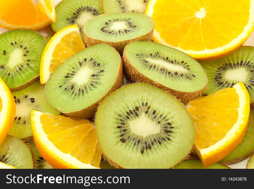 Slices of kiwi and orange on the plate. Slices of kiwi and orange on the plate