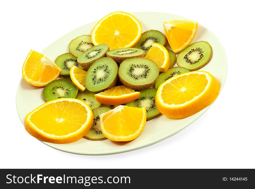 Slices of kiwi and orange on the plate isolated on the white. Slices of kiwi and orange on the plate isolated on the white