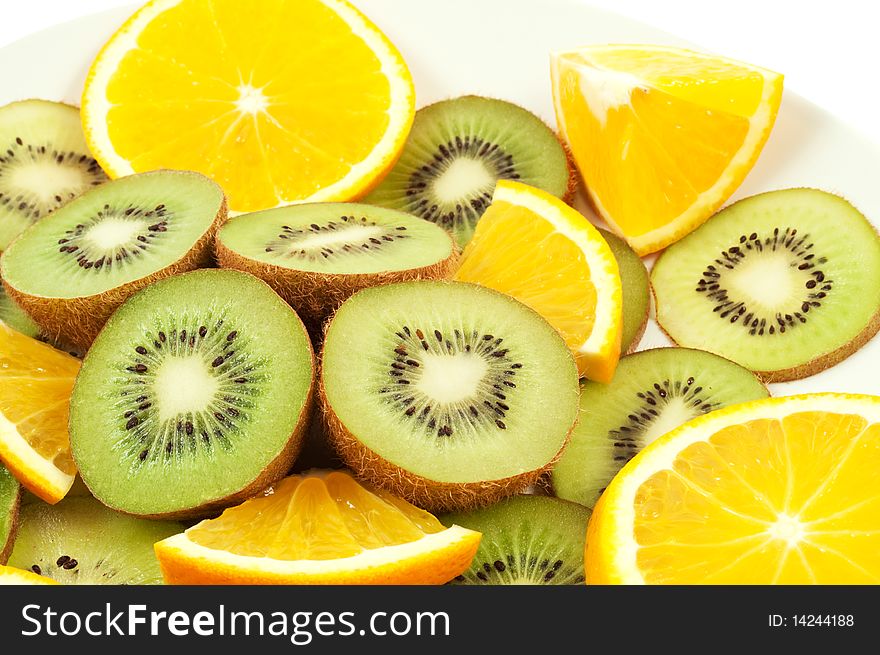 Slices of kiwi and orange on the plate. Slices of kiwi and orange on the plate