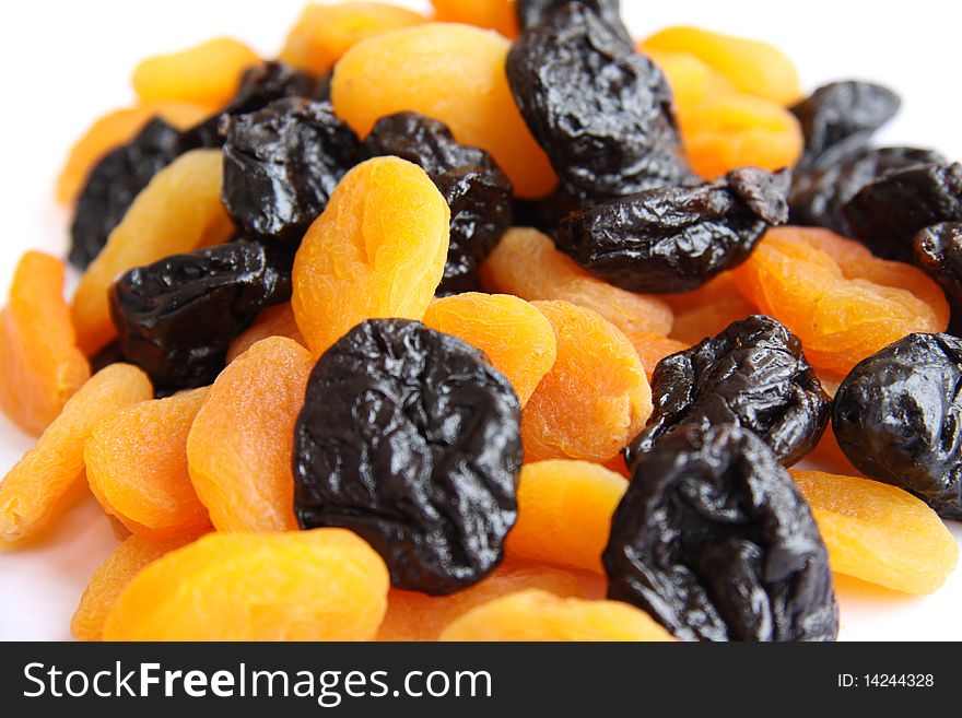 Dried plums and apricots isolated over white background