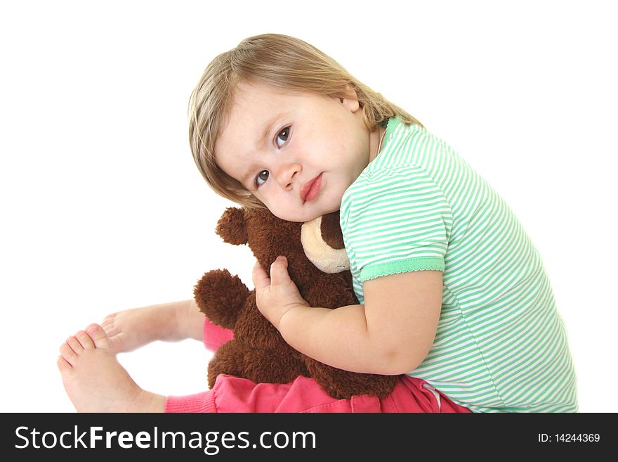 Baby girl holding her teddy bear. Isolated on white background. Baby girl holding her teddy bear. Isolated on white background
