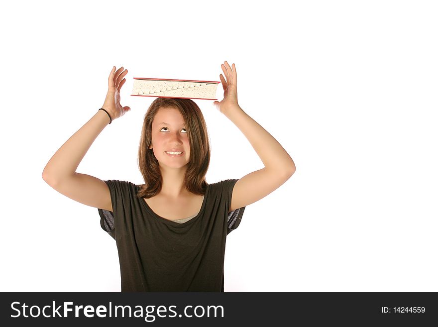 Teen girl balancing a book on her head on an isolated background