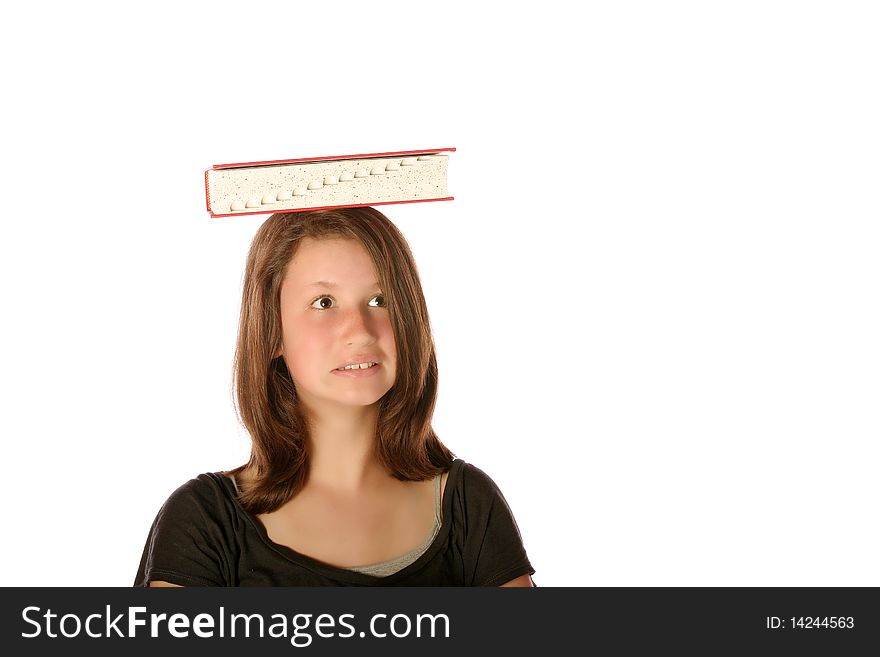 Teen girl balancing a book on her head on an isolated background