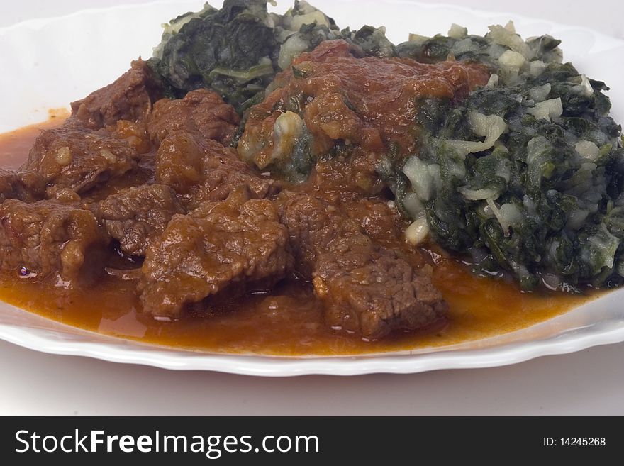 Lunch served on the table - mangold with potatoes and stewed beef - goulash. Lunch served on the table - mangold with potatoes and stewed beef - goulash.