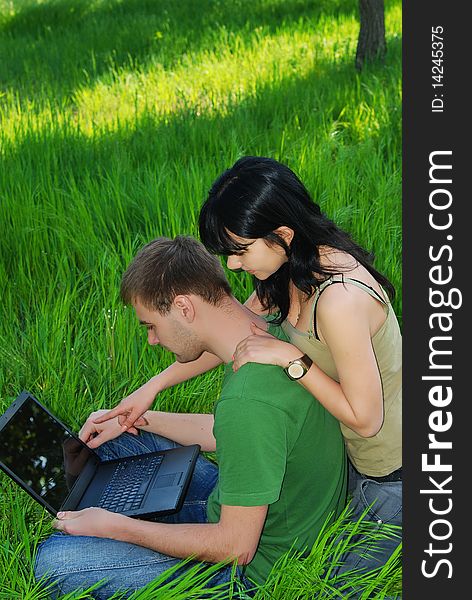 Young couple with laptop outdoor