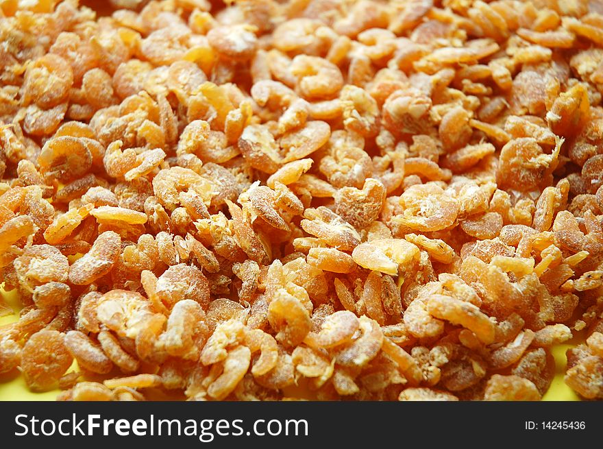 Close up of dried shrimps with yellow background