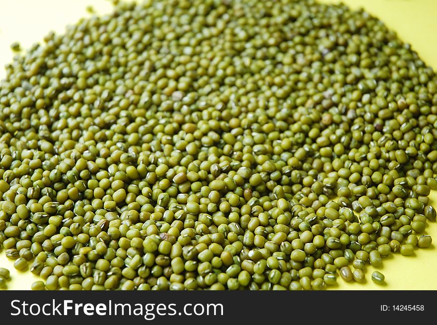 Close up of green bean with yellow background