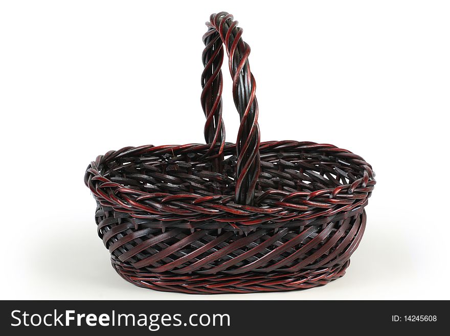An empty wicker basket isolated on a white background.