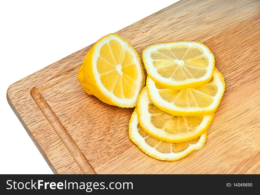 The cut lemon on a kitchen board
